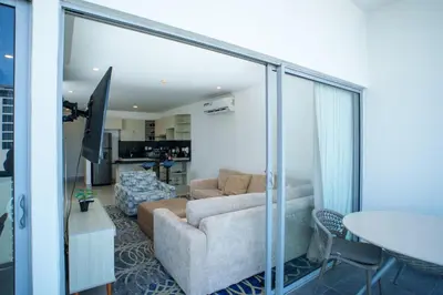 a living room with a couch and a table at I bedroom infinitum view 32nd floor in Cartagena de Indias