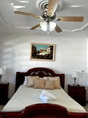 a bedroom with a bed with a ceiling fan at Beautiful Furnished House in CTG in Cartagena de Indias