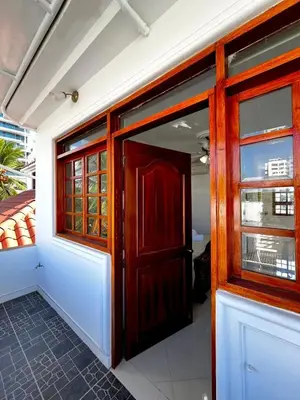an open wooden door in a room with windows at Beautiful Furnished House in CTG in Cartagena de Indias