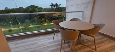 a table and chairs in a room with a large window at Baia Kristal Cartagena Kabo 2-3N in Los Arrayanes