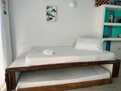 two beds sitting on top of each other in a room at Cabaña privada con Jacuzzi a solo un minuto de la playa in Isla de Tierra Bomba