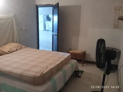 a bedroom with a bed and a blue door at Casa Solangel in Cartagena de Indias