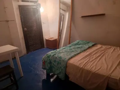 a bedroom with a bed in a room with a door at Casa Solangel in Cartagena de Indias