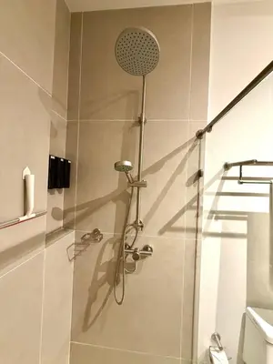 a shower in a bathroom with a glass door at Comfort and Lagoon View at Baia Kristal Cartagena in Los Arrayanes
