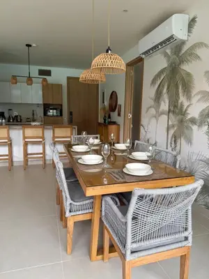 a dining room with a wooden table and chairs at Comfort and Lagoon View at Baia Kristal Cartagena in Los Arrayanes