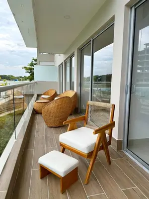 a balcony with chairs and tables and windows at Comfort and Lagoon View at Baia Kristal Cartagena in Los Arrayanes