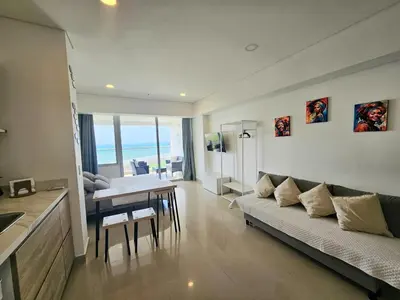 a living room with a couch and a table at Apartasuit Resort CTG Beach con vista al mar- central 5 min aeropuerto in Cartagena de Indias