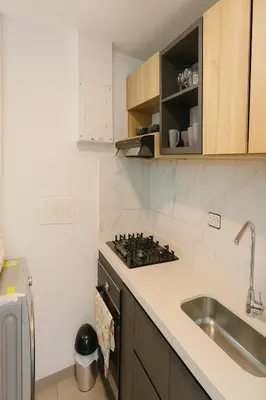 a kitchen with a sink and a stove at Oasis Costero Apartment in Cartagena de Indias