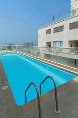 a swimming pool on the roof of a building at Oasis Costero Apartment in Cartagena de Indias