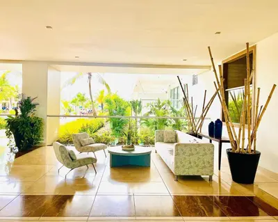 a living room with a couch and a table and chairs at Luxury apartment sea view with pool- central 12 min from the city center in Cartagena de Indias