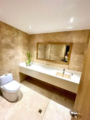 a bathroom with a toilet and a sink and a mirror at Luxury apartment sea view with pool- central 12 min from the city center in Cartagena de Indias