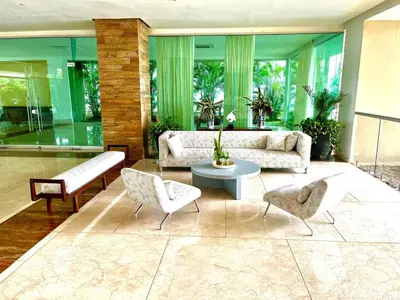 a living room with a couch and a table and chairs at Luxury apartment sea view with pool- central 12 min from the city center in Cartagena de Indias