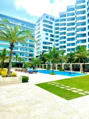 a large building with palm trees and a park at Luxury apartment sea view with pool- central 12 min from the city center in Cartagena de Indias
