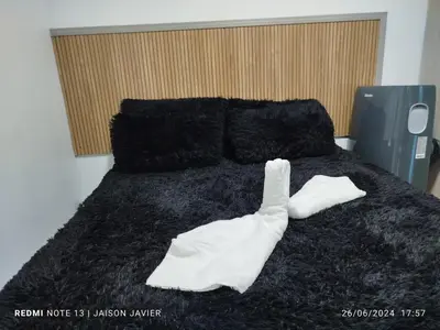 a bed with two white towels on top of it at Ciudad Amurallada in Cartagena de Indias
