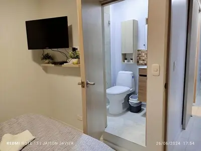 a bathroom with a toilet and a television in it at Ciudad Amurallada in Cartagena de Indias