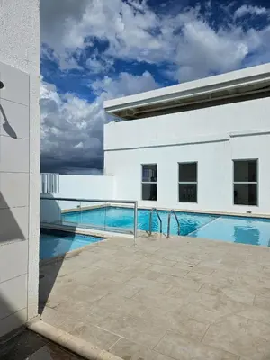 a swimming pool next to a white building at Ciudad Amurallada in Cartagena de Indias