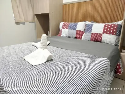 a bed with a stuffed animal shaped like a dog on it at Ciudad Amurallada in Cartagena de Indias