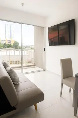 a living room with a couch and a television at VIP Cartagena Close to the 415 Wall in Cartagena de Indias