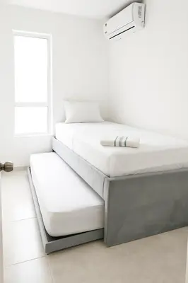 a stack of white beds in a room at VIP Cartagena Close to the 415 Wall in Cartagena de Indias