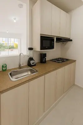 a kitchen with a sink and a microwave at VIP Cartagena Close to the 415 Wall in Cartagena de Indias