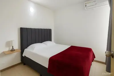 a bedroom with a bed with a red and white blanket at Cartagena near the historic center and beaches in Cartagena de Indias
