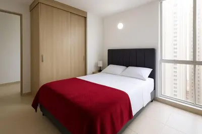 a bedroom with a large bed with a red blanket at Cartagena near the historic center and beaches in Cartagena de Indias