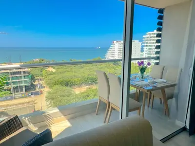 a dining room with a view of the ocean at Lujoso apartamento para estrenar Terraz - Playa Dormida in Santa Marta