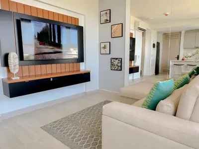 a living room with a large flat screen tv on a wall at Lujoso apartamento para estrenar Terraz - Playa Dormida in Santa Marta