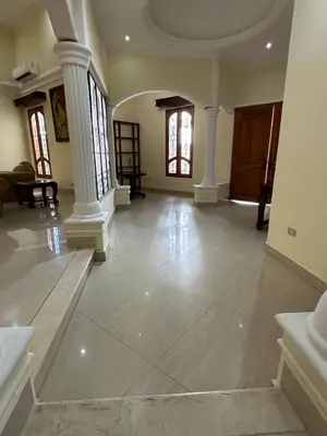 a large living room with white pillars and a large room with at Mansión Lujosa con Piscina en manga in Cartagena de Indias
