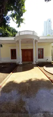a large white house with a large garage at Mansión Lujosa con Piscina en manga in Cartagena de Indias
