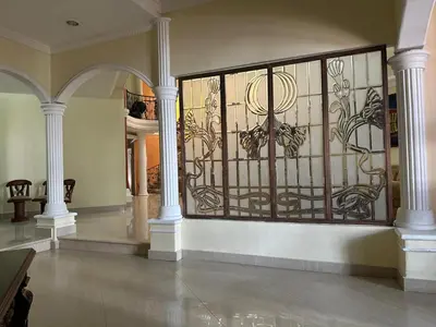 a wrought iron gate in a room with columns at Mansión Lujosa con Piscina en manga in Cartagena de Indias