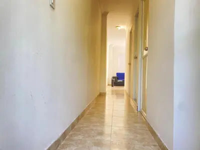 a hallway with white walls and a tile floor at Cartagena Visible Hostal in Cartagena de Indias