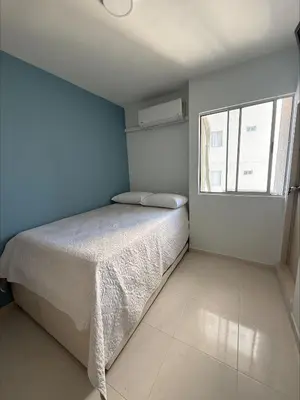 a small bedroom with a bed and a window at Piso Don Omar in Cartagena de Indias