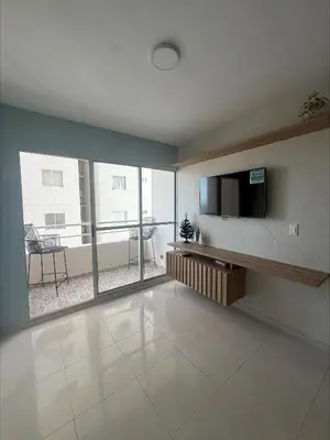 a living room with a flat screen tv and a large window at Piso Don Omar in Cartagena de Indias