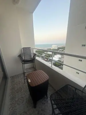 a balcony with a chair and a stool and a window at Piso Don Omar in Cartagena de Indias