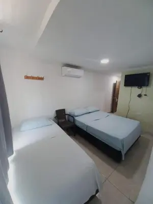 a room with two beds and a tv in it at HOTEL DIMAR i in Cartagena de Indias