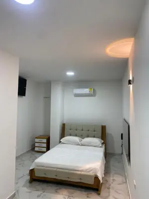 a bedroom with a bed in a white room at Hotel Santa Ana in Baranoa