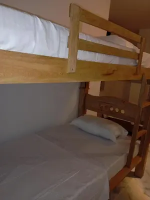 two bunk beds in a room with a pillow at Hotel Santa Ana in Baranoa