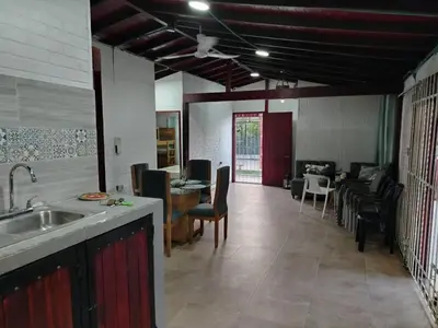 a kitchen with a sink and a living room at Casa 550 in Turbaco