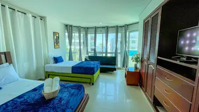 a hotel room with two beds and a television at Excepcional apartamento Cartagena in Cartagena de Indias
