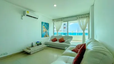 a living room with a white couch and a large window at Excepcional apartamento Cartagena in Cartagena de Indias
