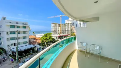 a balcony with a swimming pool and a view of the ocean at Excepcional apartamento Cartagena in Cartagena de Indias