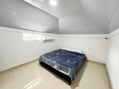 a bedroom with a bed in a white room at Apartamento en Torices, sector turistico in Cartagena de Indias