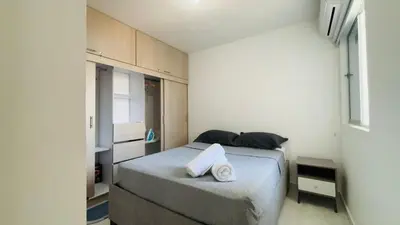 a small bedroom with a bed with two pillows at Modern Apartment Near the Sea in Cartagena de Indias