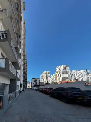 a parking lot with cars parked in front of buildings at Modern Apartment Near the Sea in Cartagena de Indias