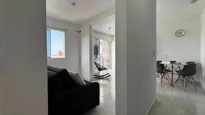 a living room with a black couch and a table at Modern Apartment Near the Sea in Cartagena de Indias