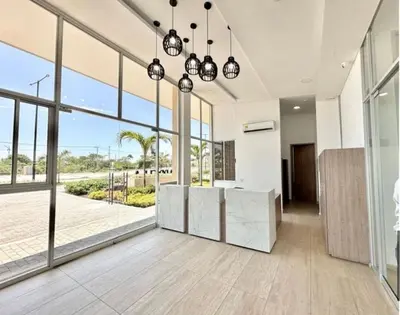 a large room with large windows and a kitchen with a view at apartment near the beach con piscina, gym y coworking in Manzanillo del Mar
