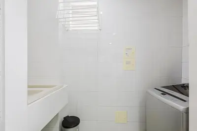a white bathroom with a sink and a washing machine at Morros Flamingo Suite - con vista al mar y acceso a la playa in Cartagena de Indias