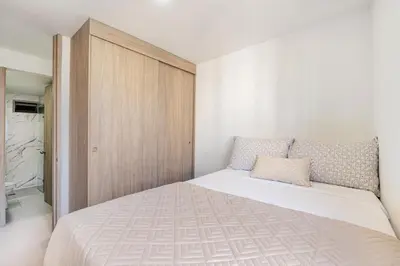 a bedroom with a large bed with a wooden cabinet at Very close to the beach and the historic center in Cartagena de Indias