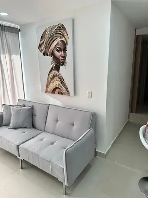 a living room with a couch and a picture of a woman at Very close to the beach and the historic center in Cartagena de Indias